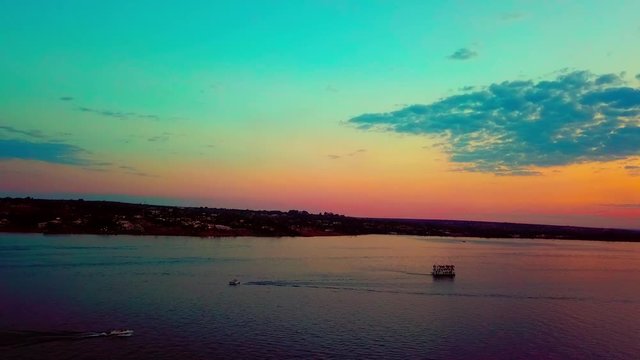 Aerial shot flying backwards over Lake Paranoa at sunset