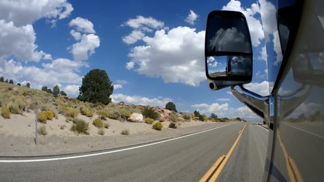 Point of view RV heading down a highway out west on vacation.