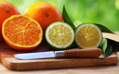 slices of citrus fruits on table and knife