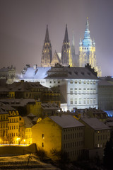 Naklejka premium Saint Vitus Cathedral. Snowy atmosphere during winter night. Unesco, Prague, Czech republic