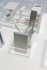 Square shape clear acrylic holder for stationery organizer on white office table