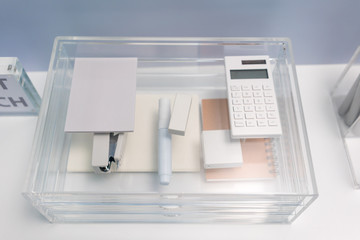 Stationery items in transparent acrylic glass organizer with drawers
