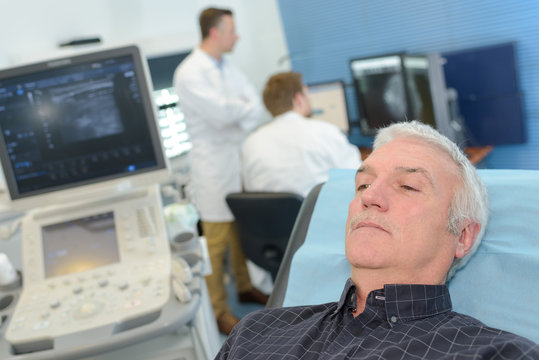 elderly man waiting for x-ray machine