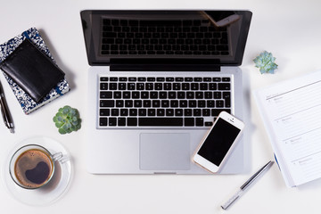 Styled white workspace with laptop, phone and coffee, flat lay top view scene