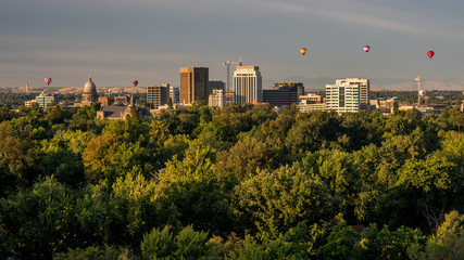 Balloons float over the city of Boise Idaho skyline