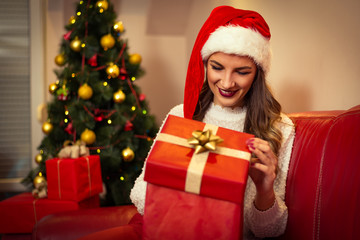 Fototapeta na wymiar Woman opening gift box. Christmas time