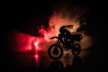 High power motorcycle chopper. Fog with backlights on background with man rider at night