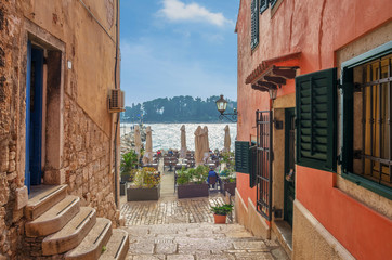 Romantic Rovinj street with a sea view.Idyllic street with old houses in town of Rovinj, Istria,...