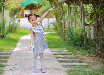 Obraz premium Cute little girl stand and stretch arms in the resort at the morning.