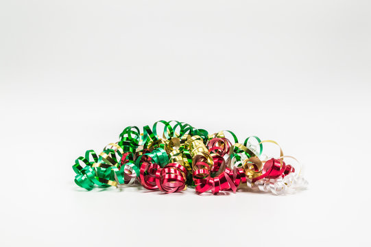 pile of colorful Christmas curling ribbon isolated on a plain background