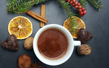 Christmas stone background with fir tree, nuts and hot chocolate