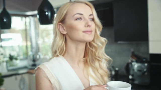 Pretty young blonde enjoying a cup of good coffee