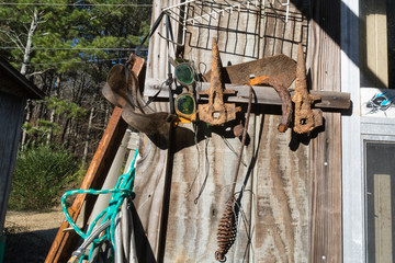 Old welder's goggles and rusty farm implements and tools decorate a flea market near Interstate 20...