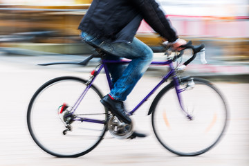 person with a racing bicycle in motion blur