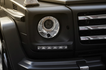 Obraz na płótnie Canvas Suv car headlight photo with grille.