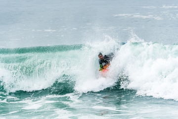 Bodyboarder surfing ocean wave