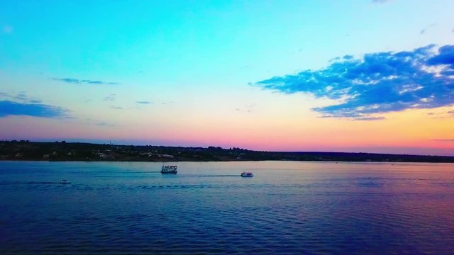 Slow aerial drone shot flying over Lake Paranoa at dusk