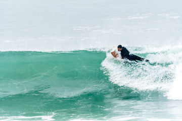 Bodyboarder surfing ocean wave