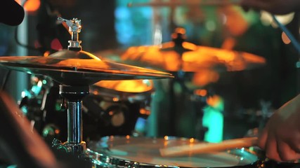 Young man playing electronic drums on stage. Concert. Neon light. Live music background. Drum kit on stage lights performance.Festival and show background. Slow motion - Powered by Adobe