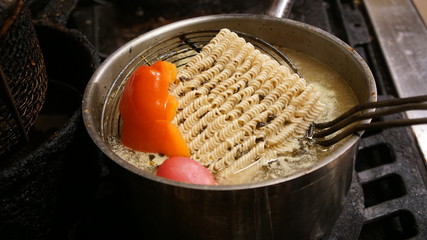 Asian noodles boiling in a pot