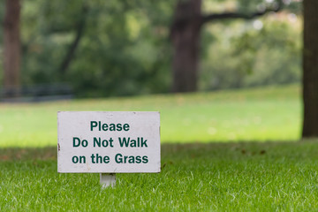 please do not walk on grass sign outside on green grass 