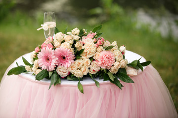 Wedding flowers and champagne glass on table. Ready for wedding ceremony