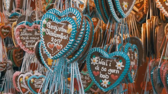 MUNICH, GERMANY, SEPTEMBER 16, 2017: Traditional Colorful Gingerbread Heart Shaped at the Oktoberfest Festival, Bavaria, Germany. Showcase Tent shop with festive pastries. World Beer Festival.