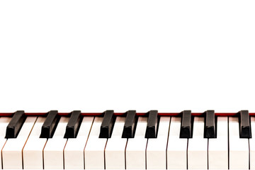 Black and white keys of a white grand piano. Copy space. For information on the musical theme.