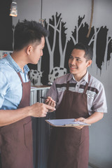 coffee shop owner discussing with his employee