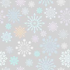 Seamless pattern with large and small colorful carved snowflakes on white background
