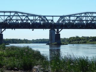 Railway bridge across the river. Pillars and arches of the railway bridge. Photo