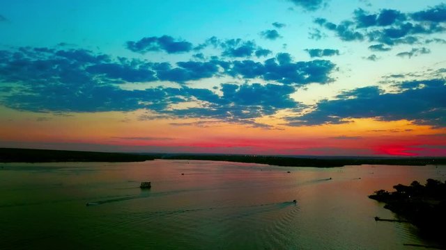 Aerial shot descending from high above Lake Paranoa at sunset
