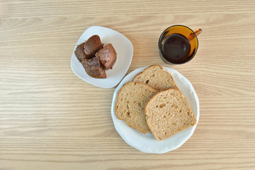 Top view of Brazilian typical coffee break with cake, bread and cup of coffee on a wood table