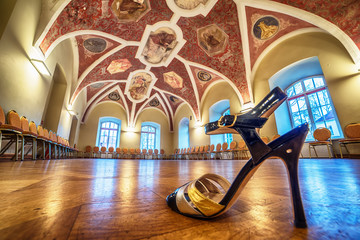 Interior: a beautiful hall with paintings, a tango shoe in the foreground - obrazy, fototapety, plakaty