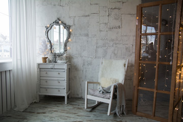 An old-style room with a mirror and rocking chair
