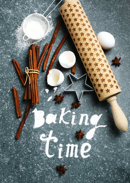Baking time. Flour sprinkled on the blue table with text baking time. Baking ingredients.