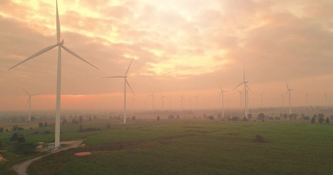 4K Aerial view of Wind turbines farm in the green field,  One of the cleanest, renewable electric energy source.Future sustainable power.Blue sky with corn field location,THAILAND