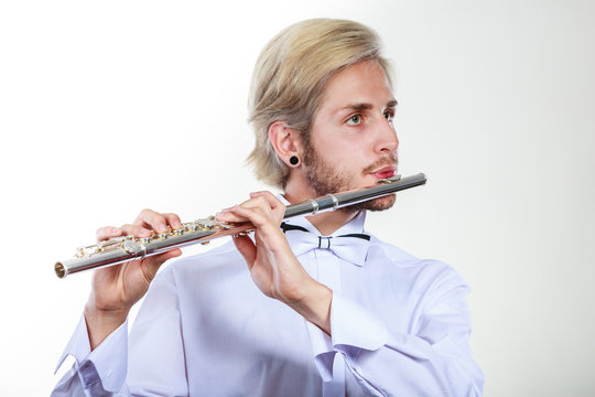 Male flutist playing his flute