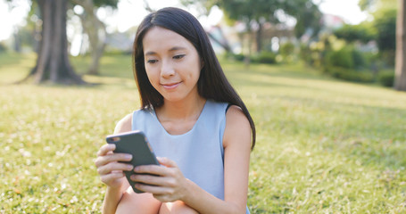 Woman watching on mobile phone at outdoor