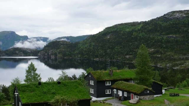 Norvegian Houses with Green Roof in a Lake. Natural Landscape in 4K Time Lapse