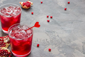 Pomegranate juice with ice in glass decorated heart