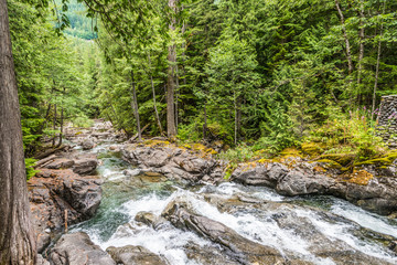 Naklejka na ściany i meble Landscape of Waterfalls Deception Creek Falls Flowing through Old-Growth Fir Forest along Nature Hiking Trail, Cascade Mountains, Washington State, Pacific Northwest