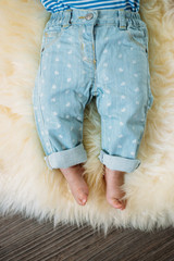 legs of a newborn in jeans