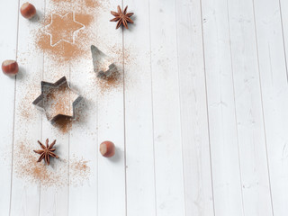 Abstract background with molds for cookies anise star tree cinnamon light wooden table