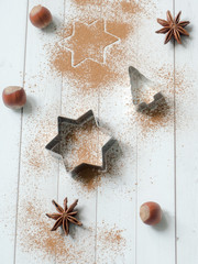 Abstract background with molds for cookies anise star tree cinnamon light wooden table