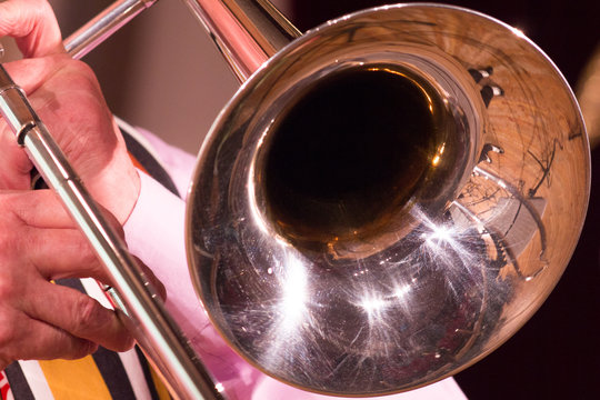 A man on a trombone plays jazz or other music.