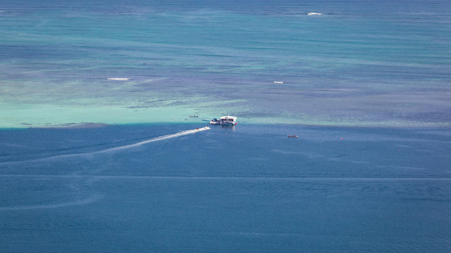 Kaneohe sandbar seascape background with boats and pristine, tropical, blue waters.