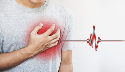 a man touching his heart, with heart pulse sign. Heart attack, and others heart disease concepts