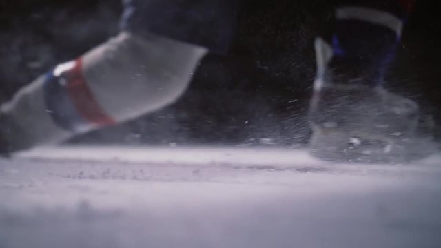Professional hockey player produces a shot on goal at ice arena. Close-up. Slow motion
