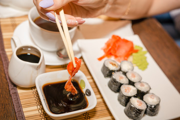 Eating sushi and rolls in a Japanese restaurant